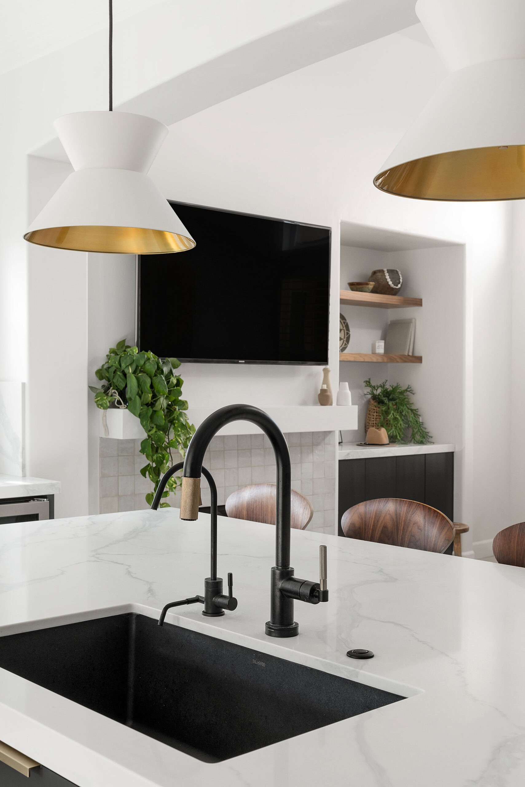 Bright modern kitchen with sleek black sink and stylish pendant lighting.