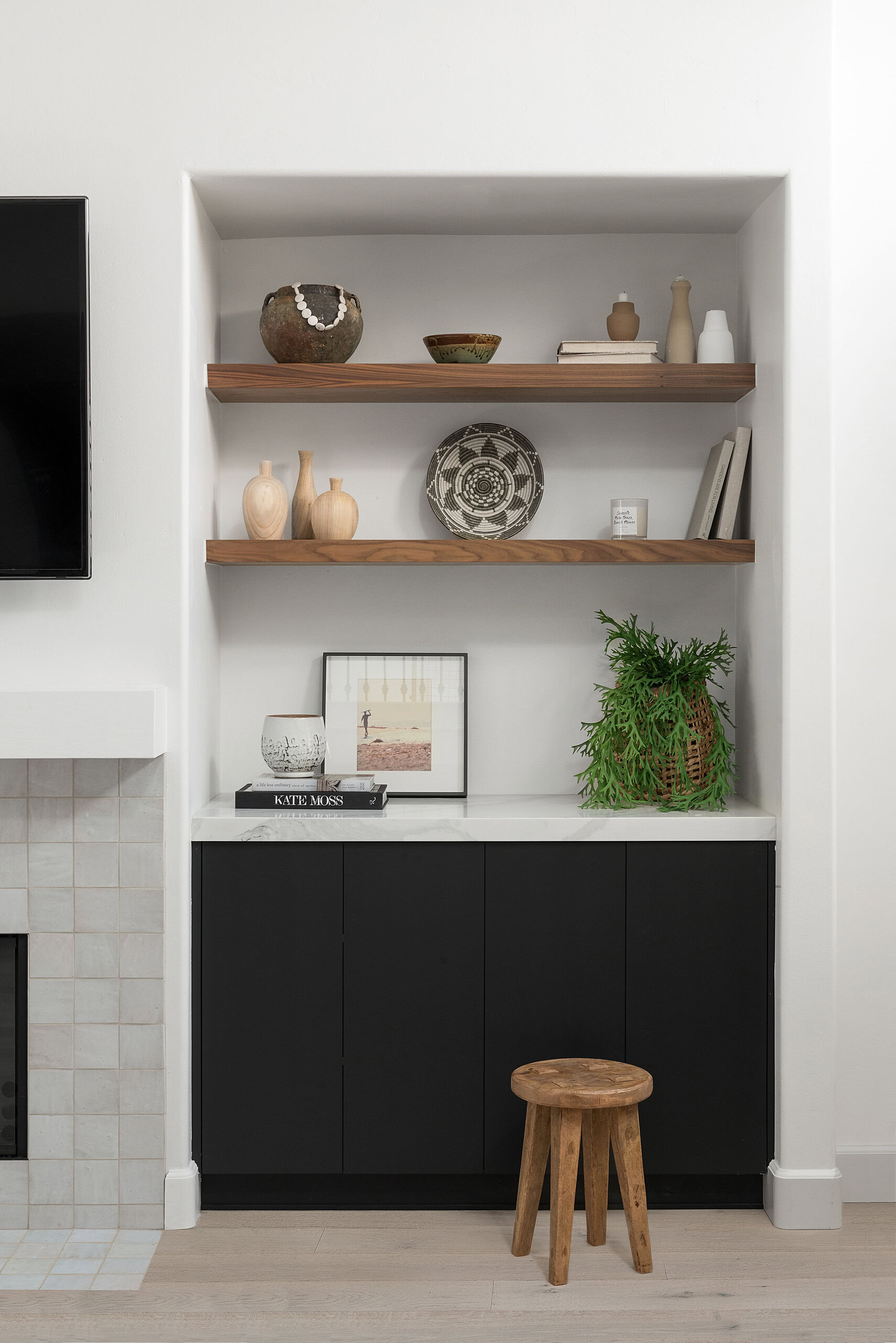 Built-in shelves with ceramics and plants in a Point Loma interior.
