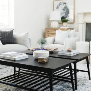 Modern coffee table with decorative items in a bright, contemporary living room setting.