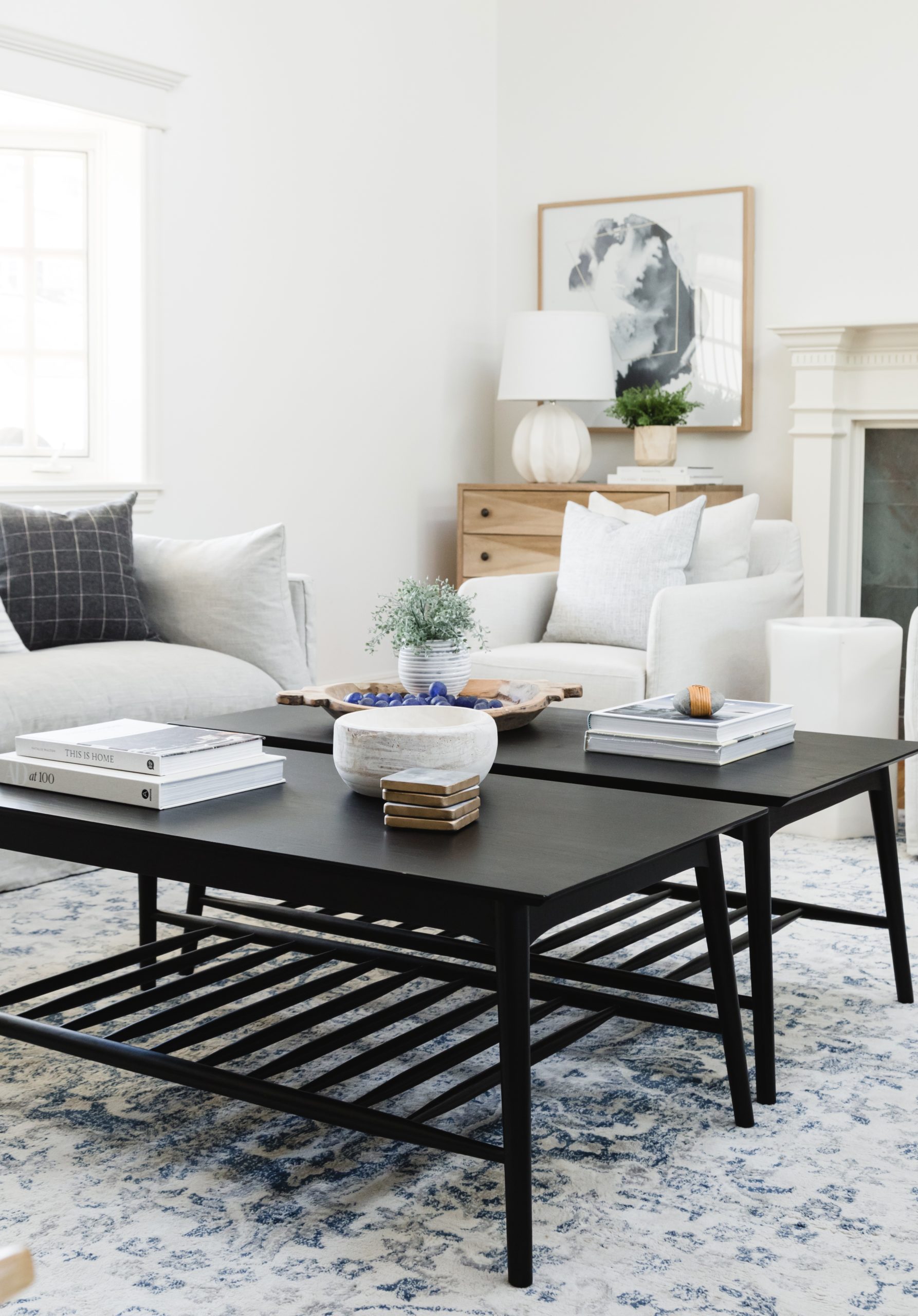 Modern coffee table with decorative items in a bright, contemporary living room setting.