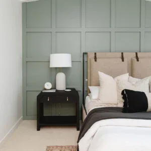 Elegant bedroom with timeless wood-paneled walls and cozy decor.