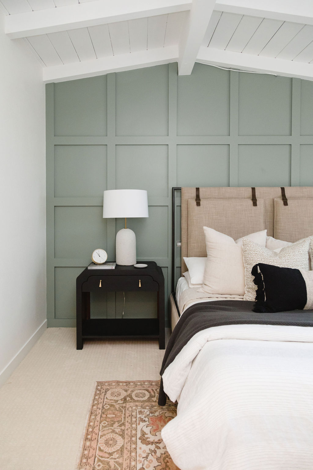 Elegant bedroom with timeless wood-paneled walls and cozy decor.