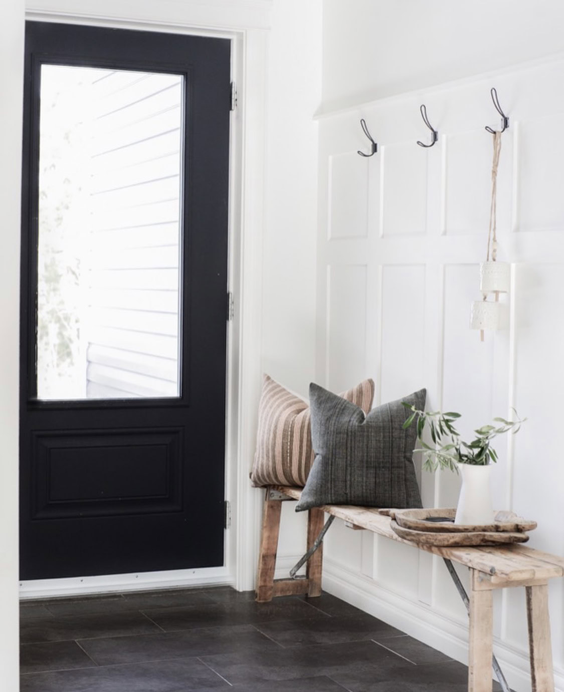 Modern interior with wood-paneled walls and cozy decor accents.