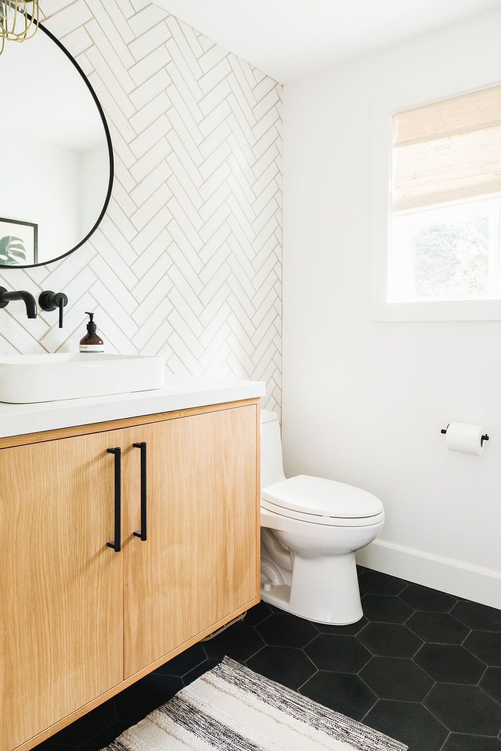 Bathroom tile ideas for contemporary interiors with stylish herringbone pattern.
