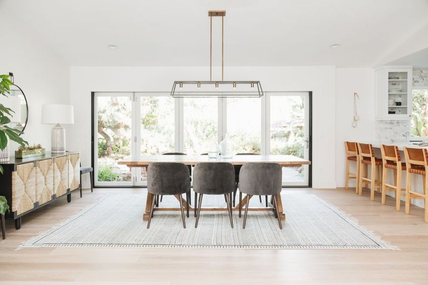 Modern dining room with large windows and minimalist decor.