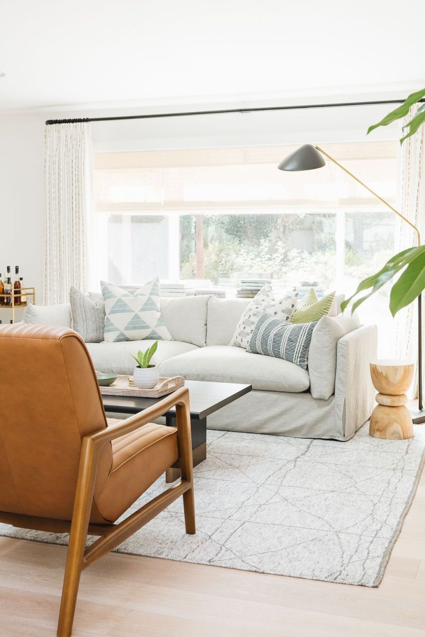 Bright living room with large window and stylish decor.