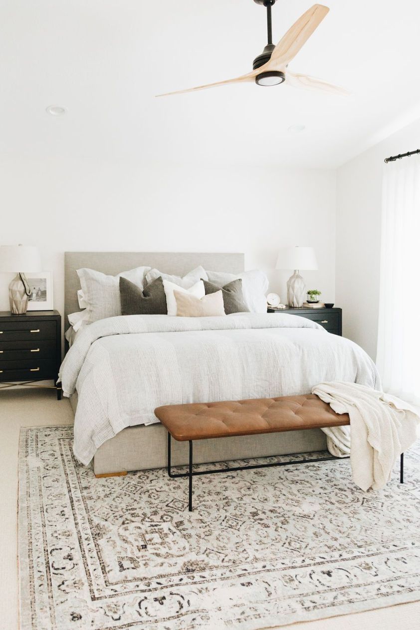 Elegant bedroom with a large, plush rug, neutral tones, and contemporary furnishings for a cozy, sty.