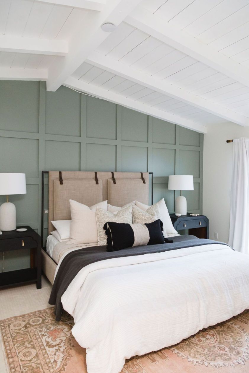 Stylish bedroom featuring a plush rug, neutral bedding, and modern decor for a cozy ambiance.
