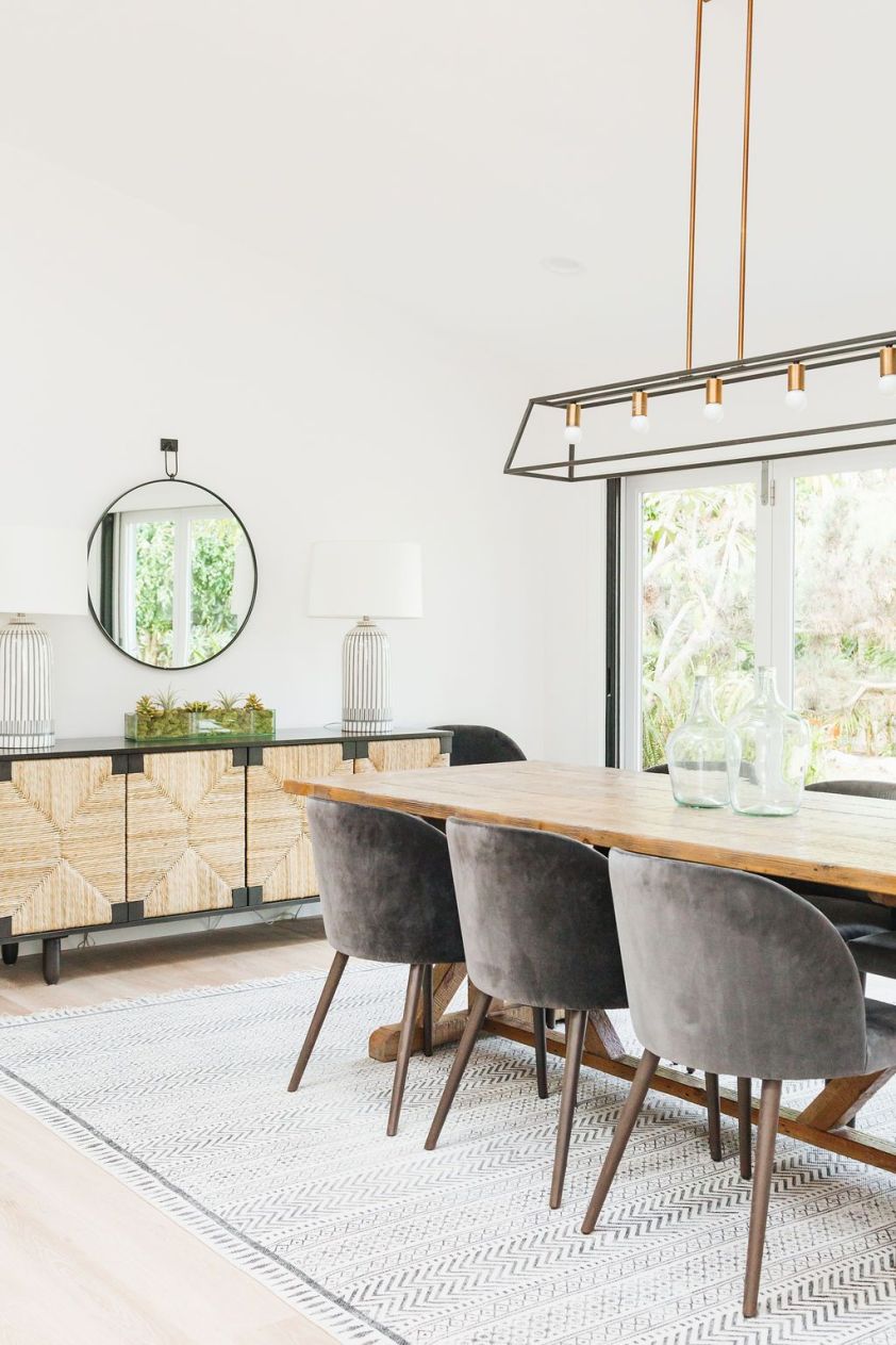 Elegant dining room with stylish rugs, modern lighting, and contemporary furniture. Perfect for cozy.