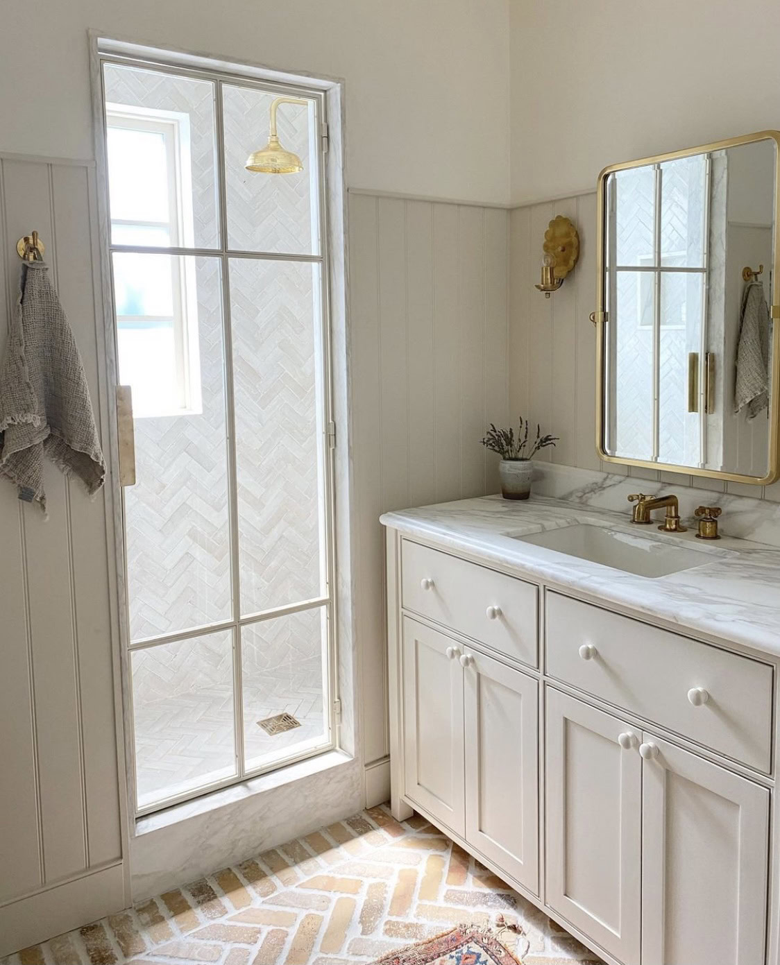 Bathroom interior with classic white vanity and marble countertop.