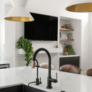 Elegant kitchen faucet with black finish and gold accents, perfect for contemporary interior design.