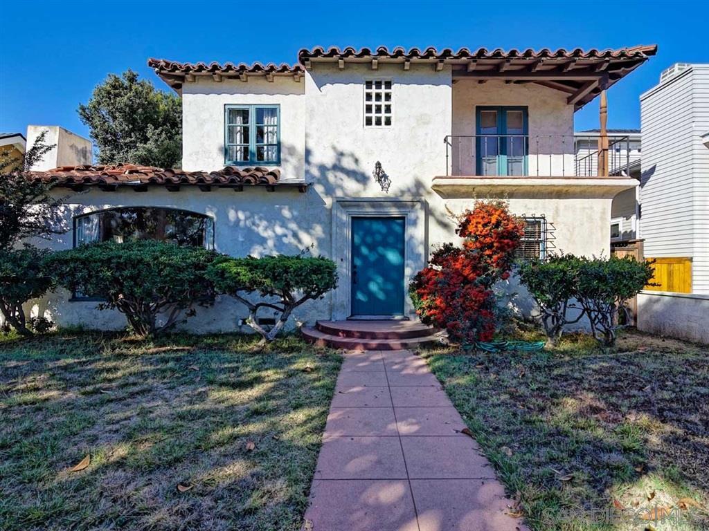 Beautiful Spanish-style house exterior with lush landscaping and vibrant garden.