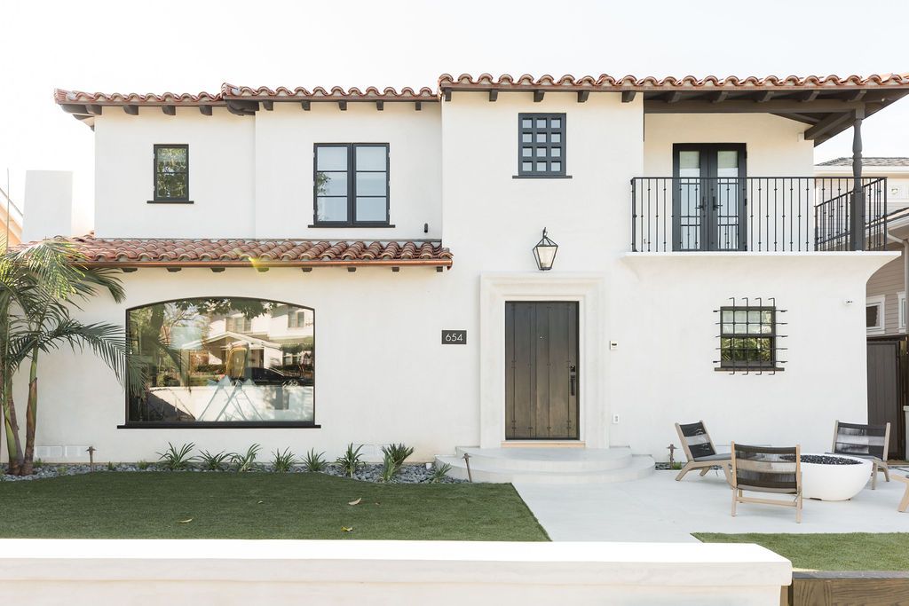 Beautiful Spanish-style home with white stucco walls and terracotta roof tiles.