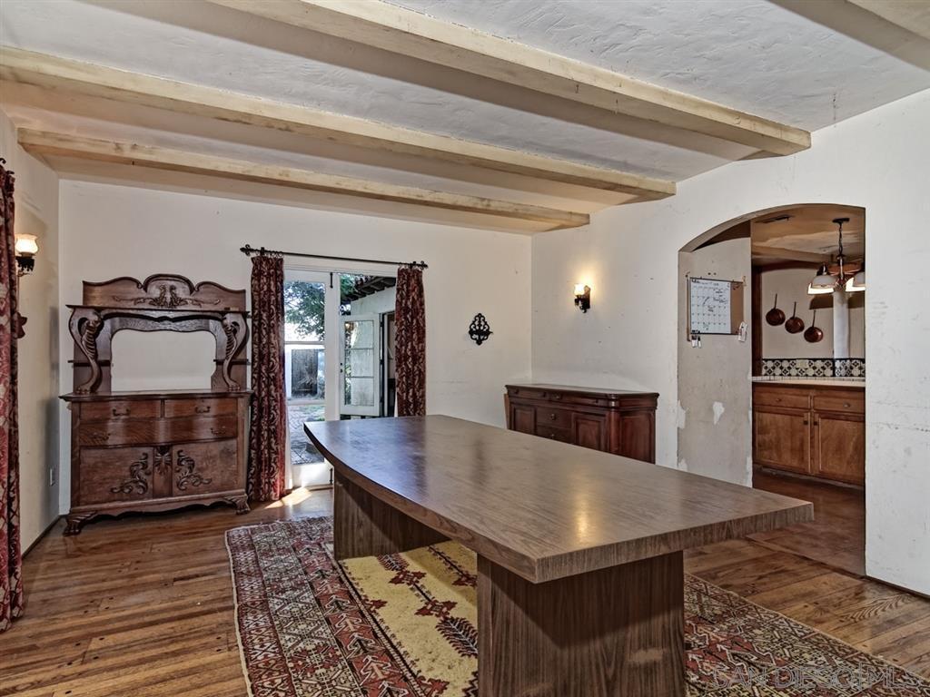 Elegant dining room with rustic wooden table and vintage furniture.