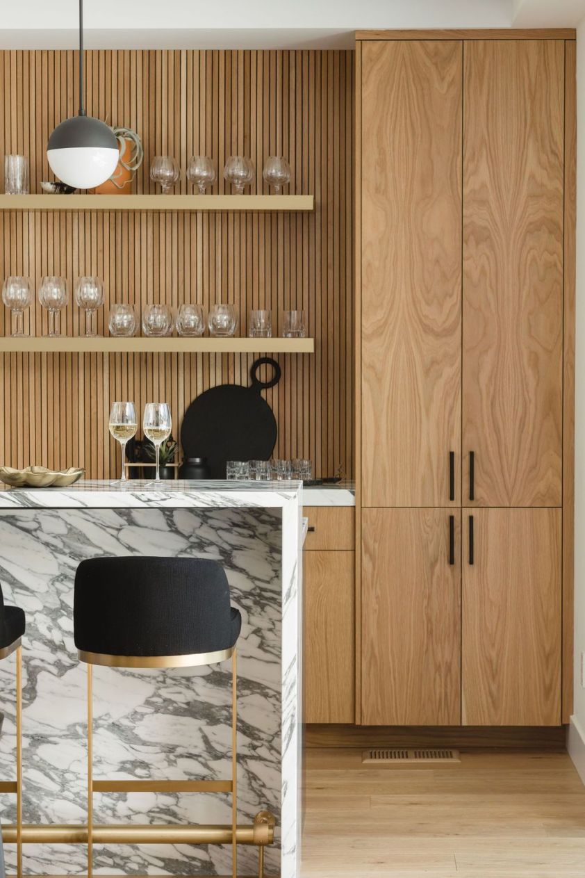 Stylish wooden kitchen cabinets with marble countertop and open shelving.