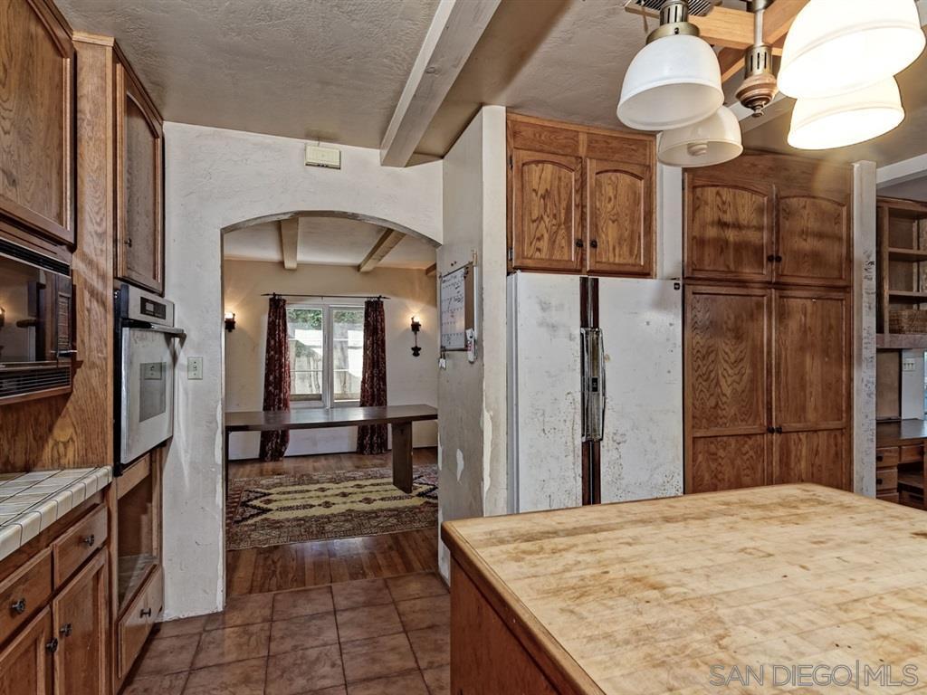 Modern kitchen with wooden cabinets and updated appliances.
