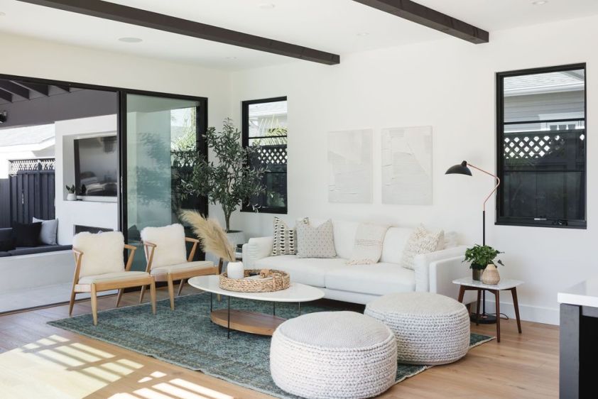 Bright modern living room with white walls, large windows, and contemporary furniture.