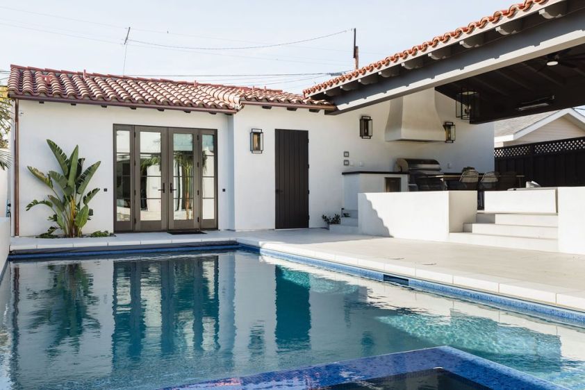 Elegant backyard pool area with modern design and outdoor living space.