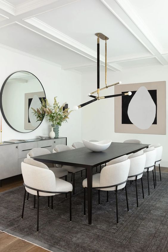 Ceiling design featuring layered moldings and sleek lighting enhances dining room interest.