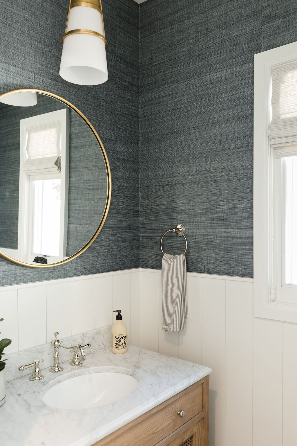 Modern bathroom featuring stylish grasscloth wallpaper and contemporary fixtures.