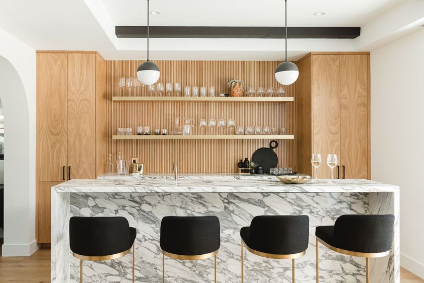 Elegant kitchen featuring marble countertop and minimalist wooden cabinets for contemporary interior.
