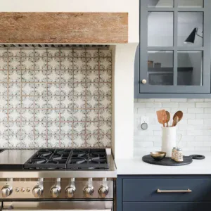 Dark Blue Kitchen Cabinets with Patterned Backsplash Tiles.