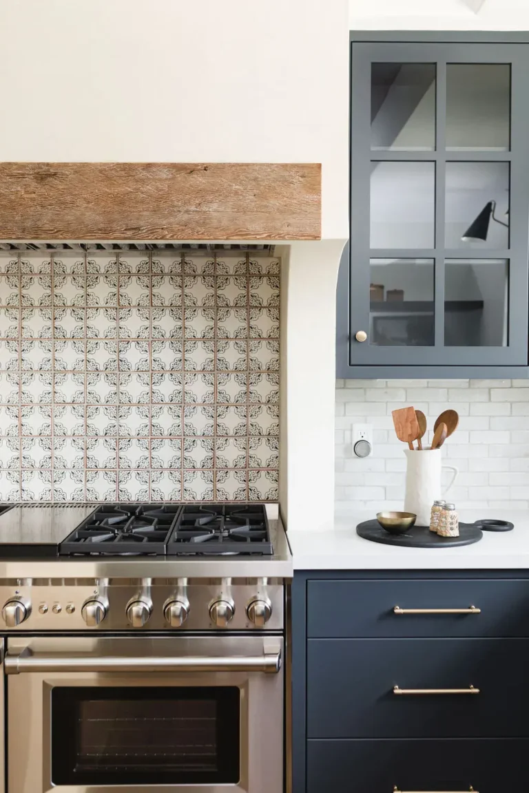 Dark Blue Kitchen Cabinets with Patterned Backsplash Tiles.