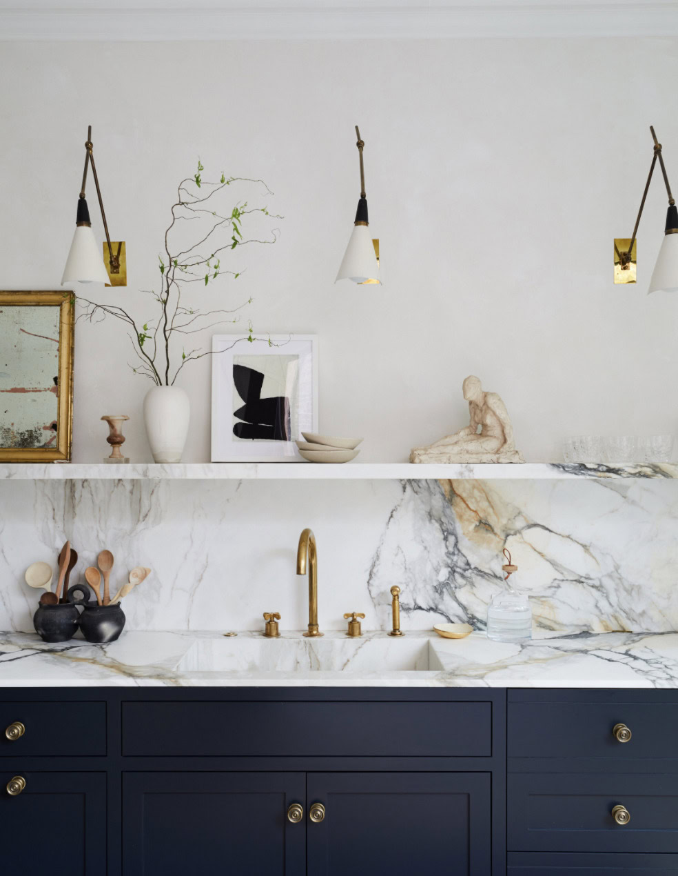 Dark paint kitchen backsplash with elegant gold fixtures and minimalist decor.
