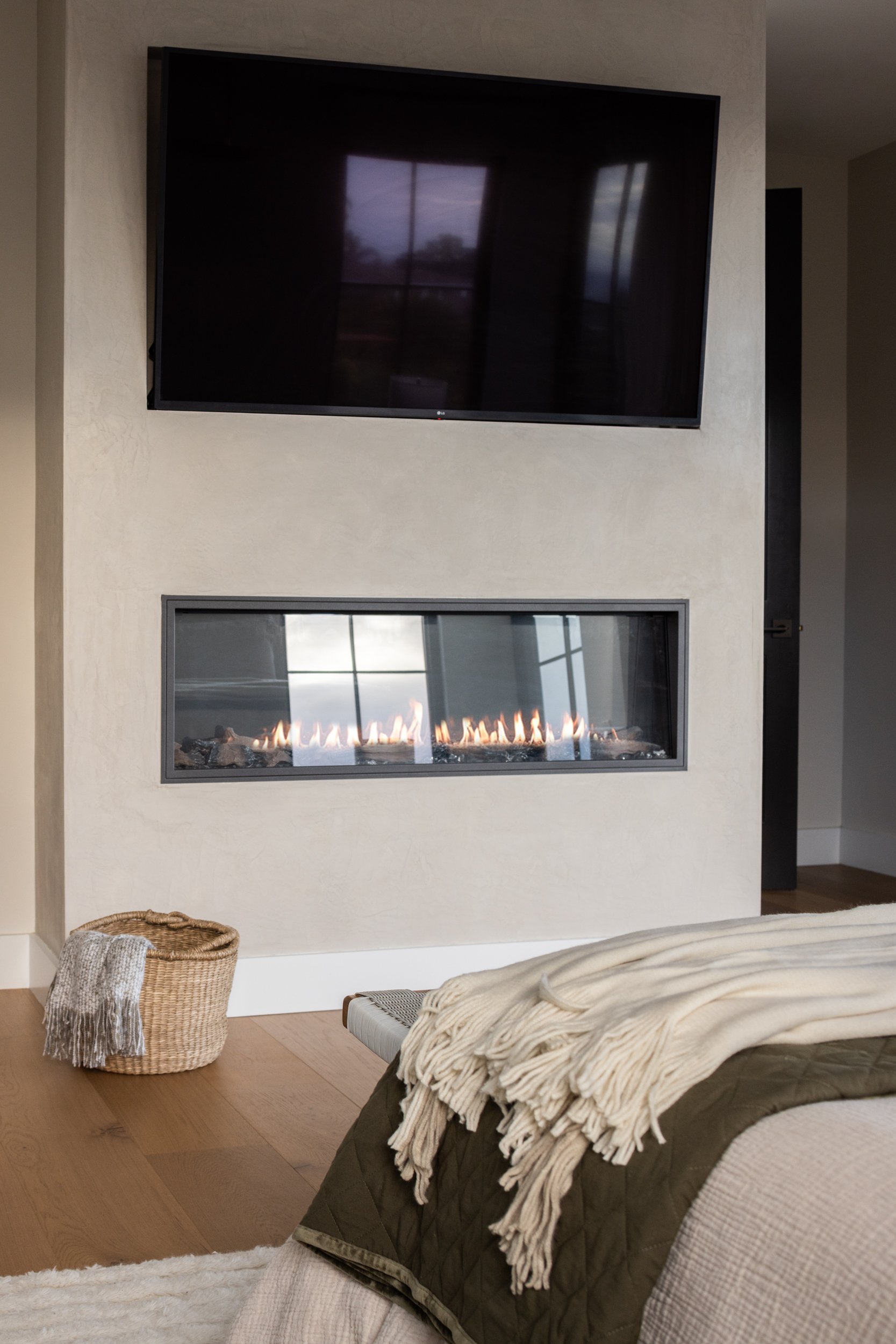 Modern living room with fireplace and flat-screen TV.