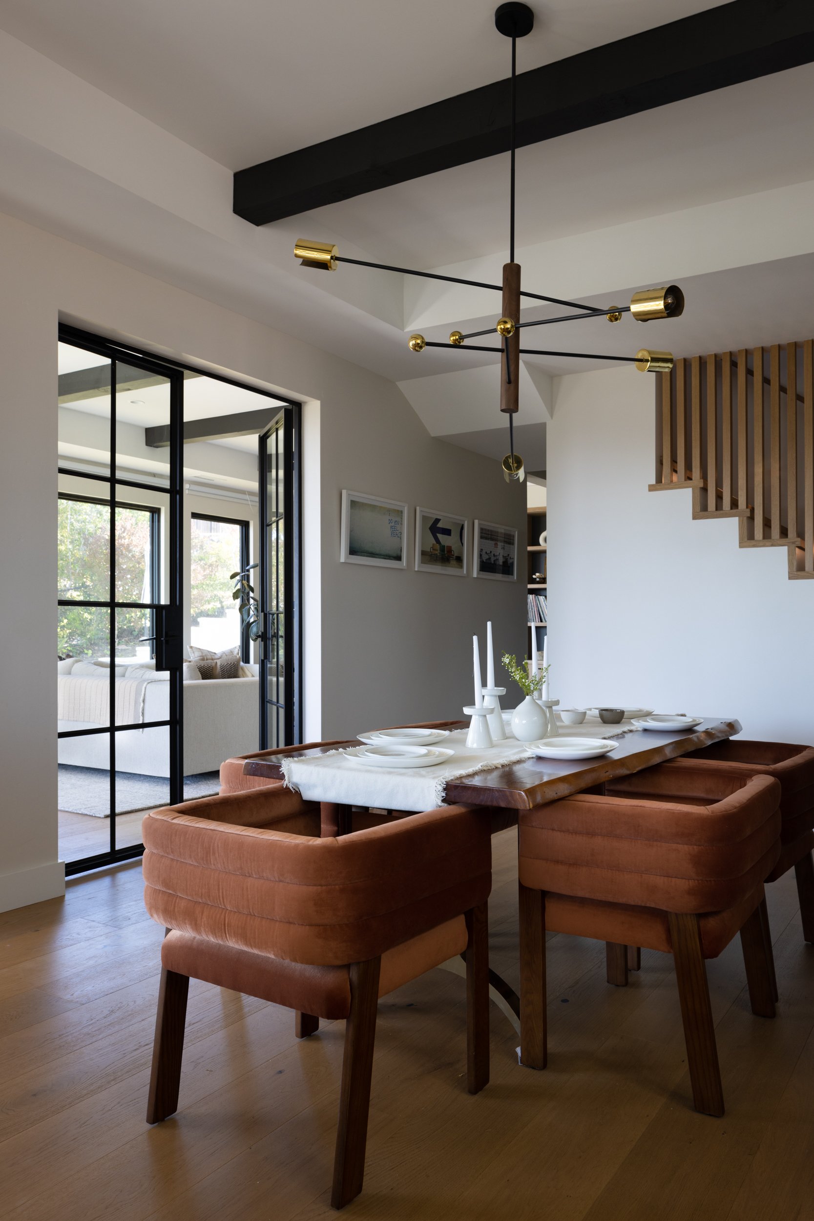 Elegant dining area featuring contemporary furniture and a sleek chandelier.