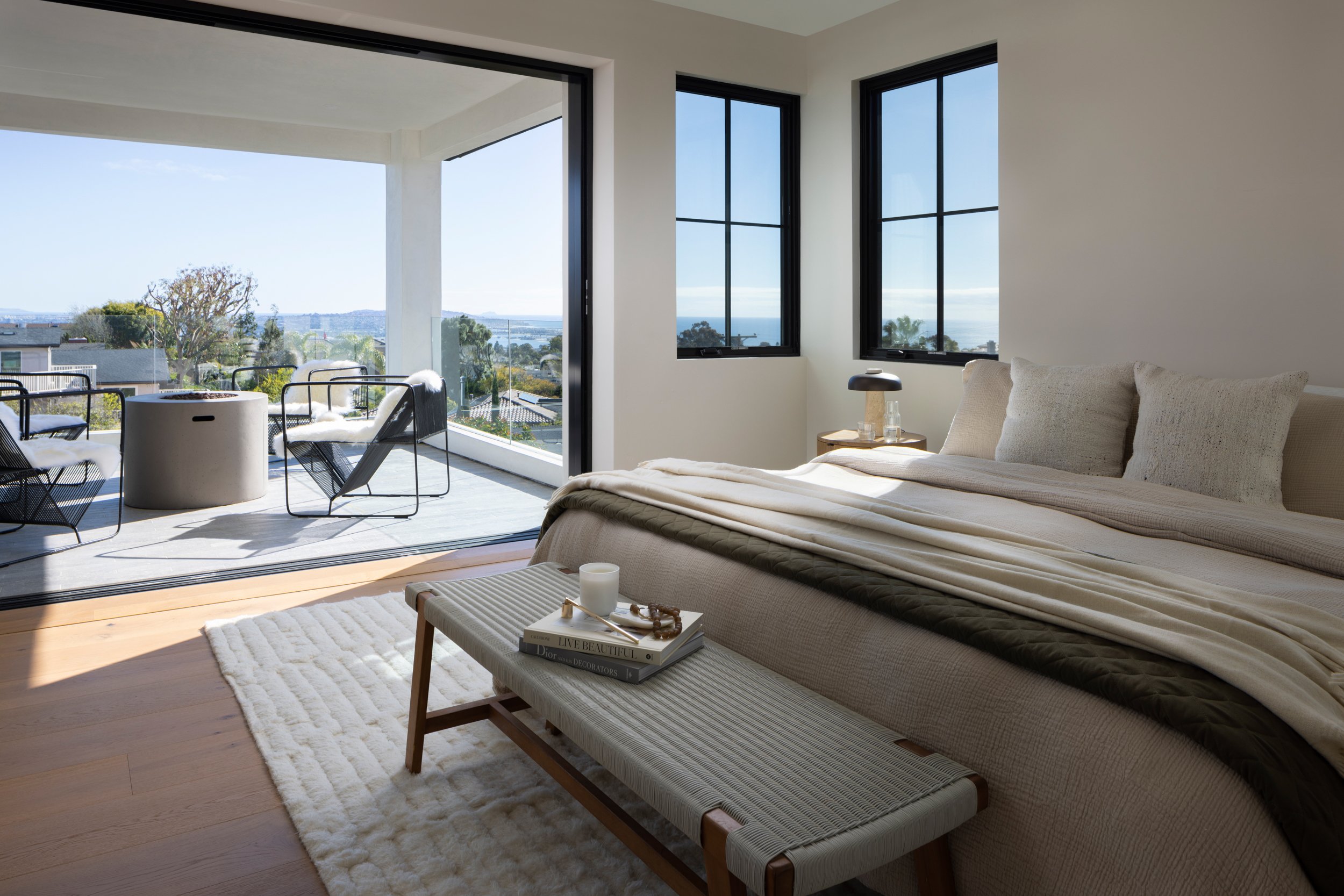 Bright bedroom with panoramic views and stylish decor.