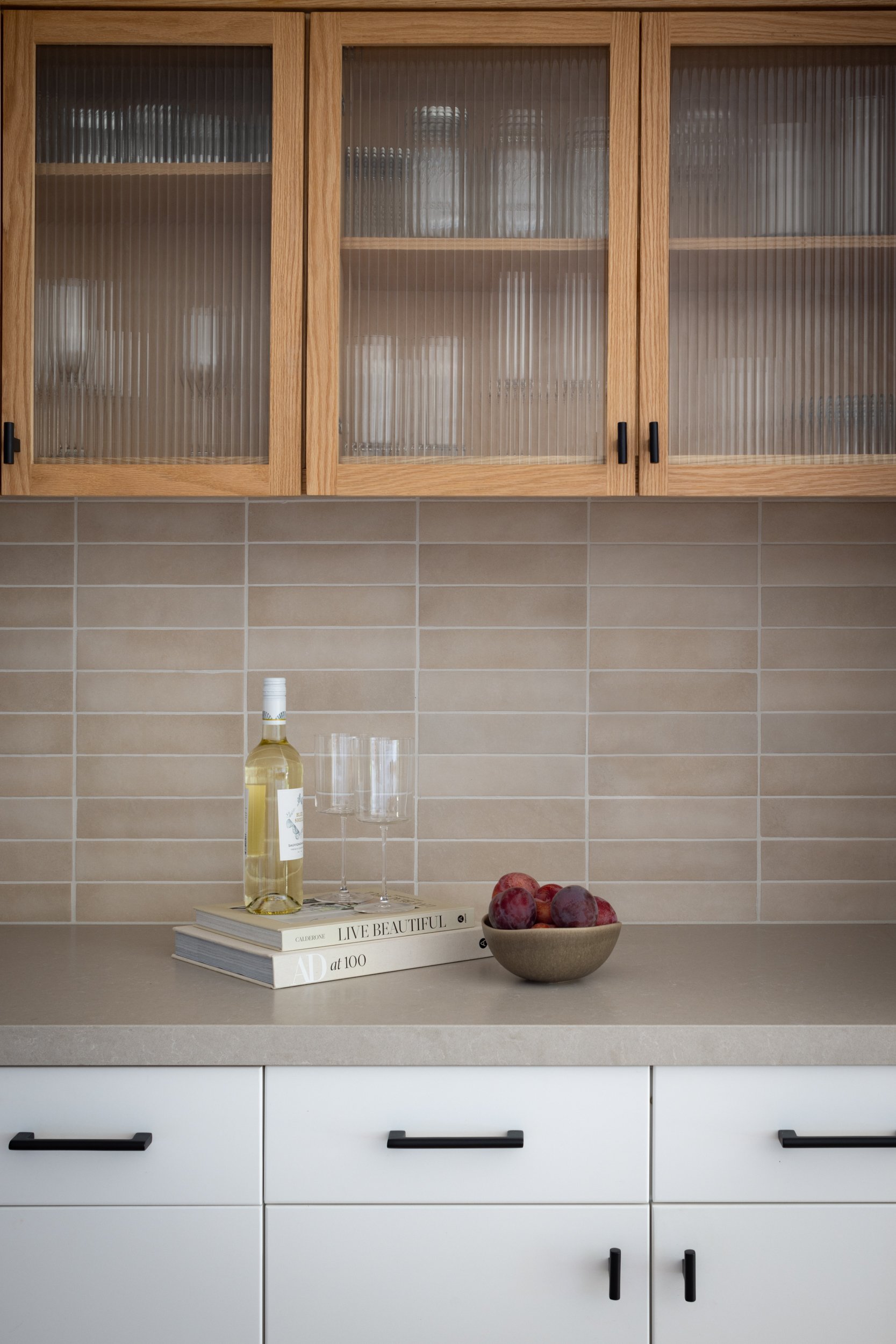 Elegant Hermosa kitchen with wooden cabinetry and modern neutral backsplash design.