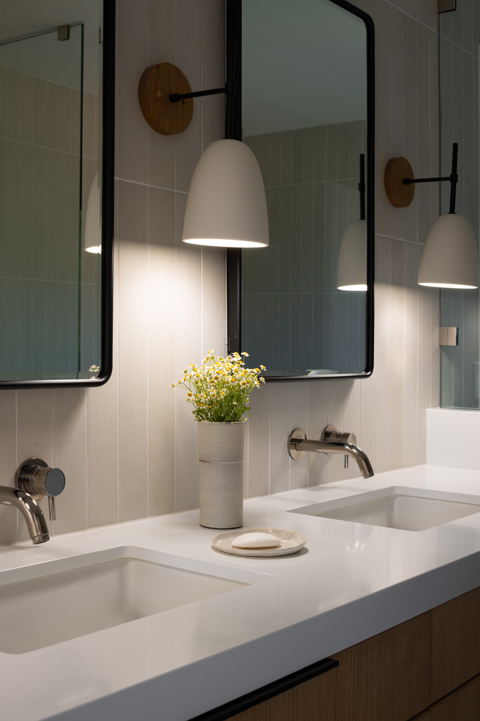 Elegant bathroom interior featuring dual sinks, mirrors, and contemporary decor.