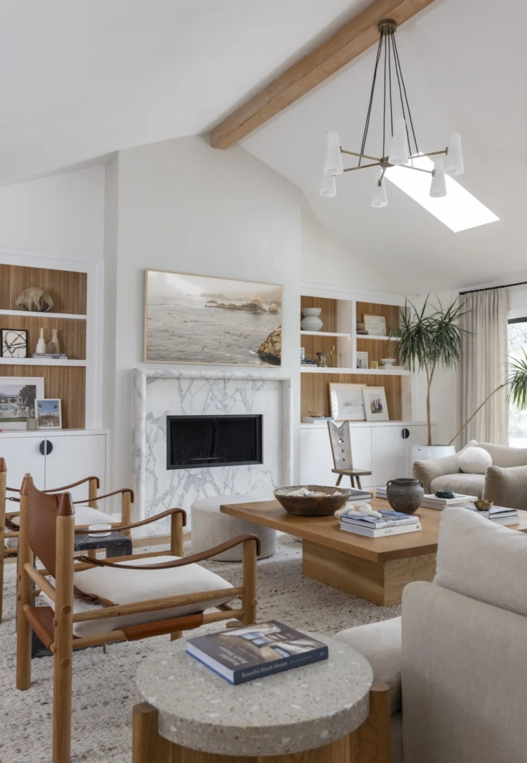Coastal living room interior with white walls, wooden beams, and stylish decor.