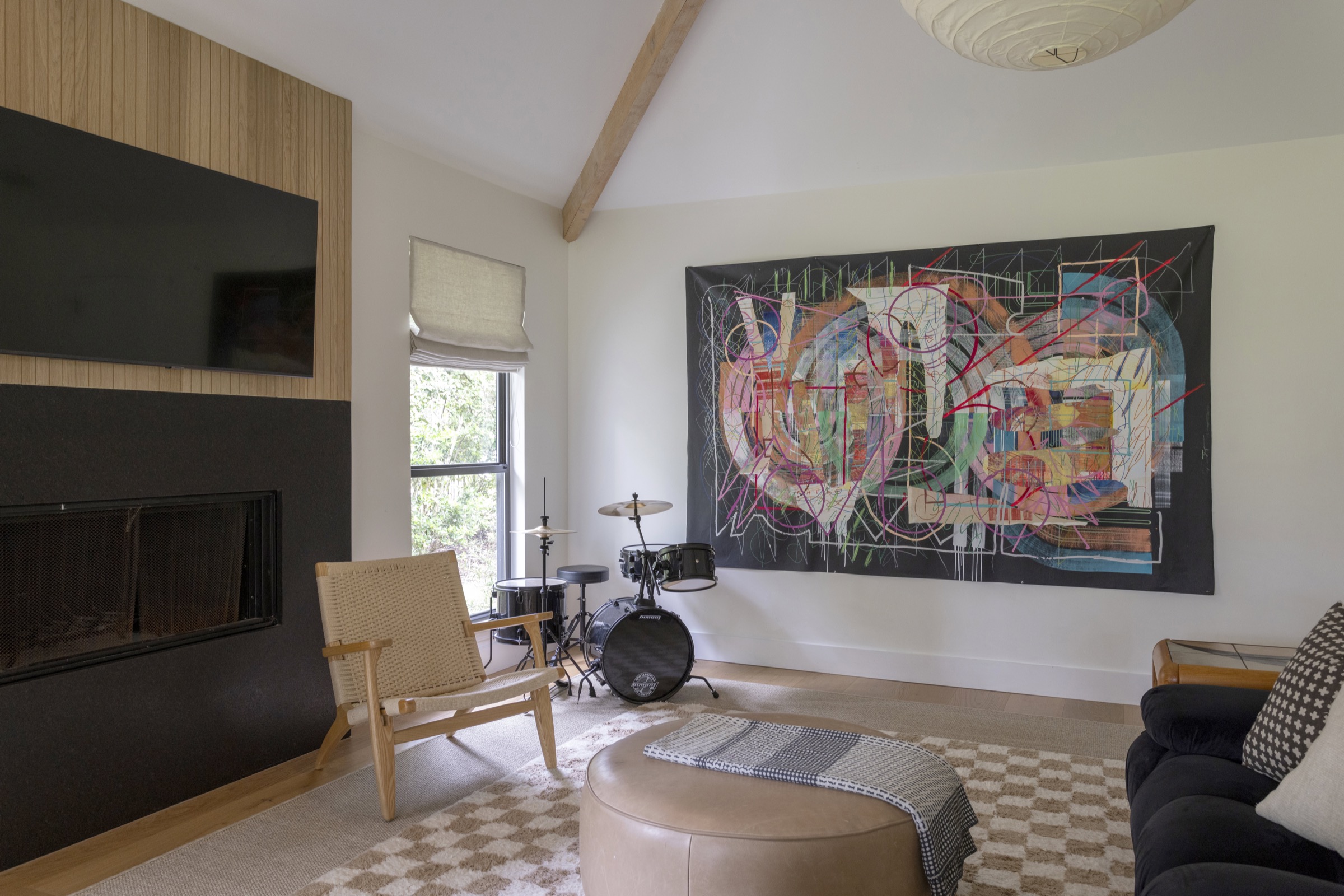 Bright living room featuring colorful abstract art and musical instruments for a lively atmosphere.