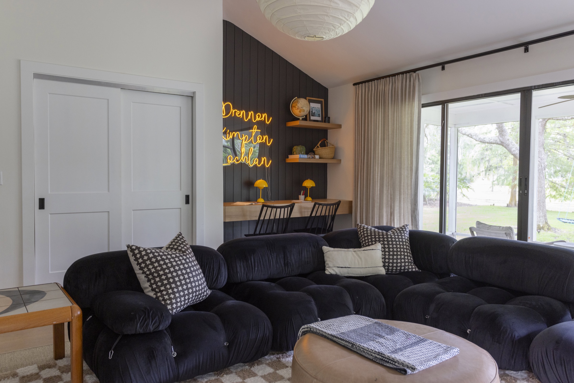 Stylish living room with black sectional sofa and natural light.