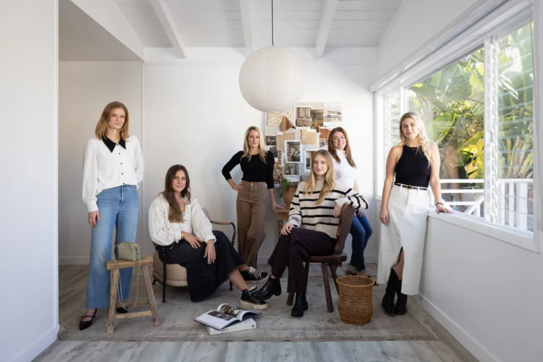 Team at South Harlow Interiors in a bright, modern workspace with natural light and stylish decor.
