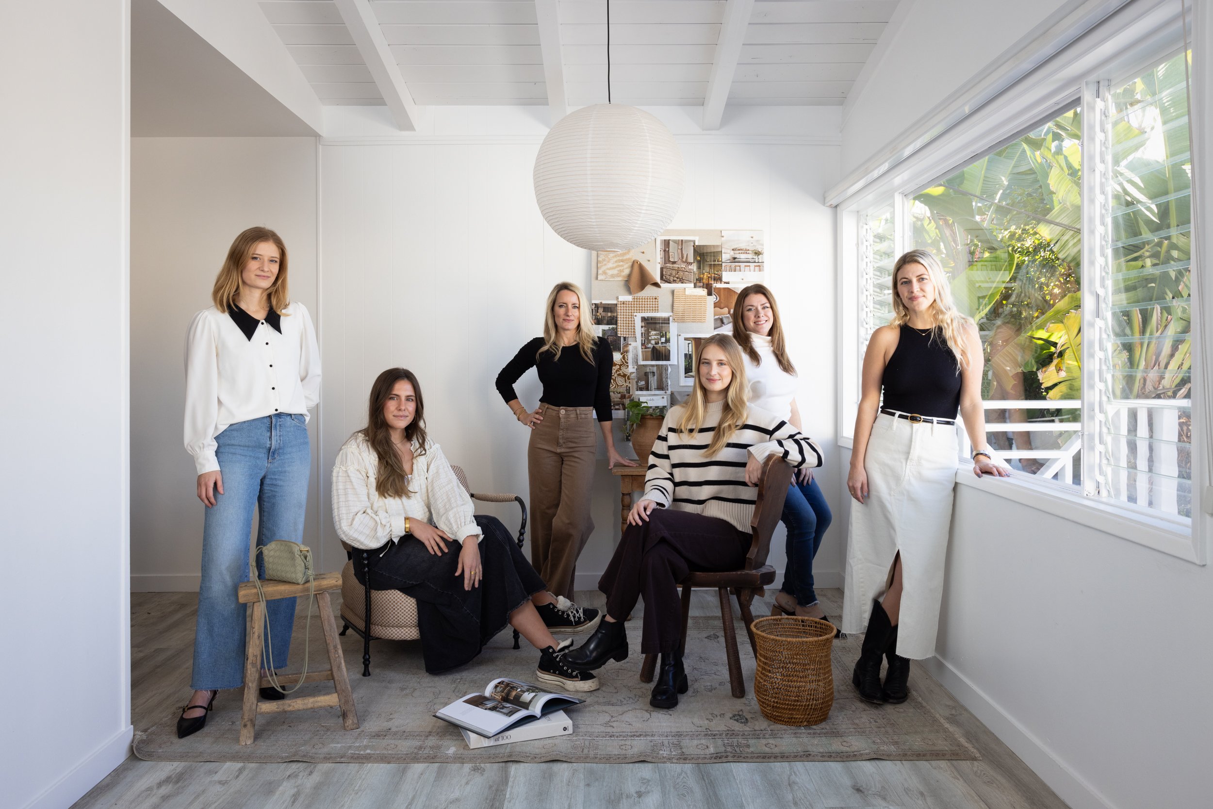 Team at South Harlow Interiors in a bright, modern workspace with natural light and stylish decor.