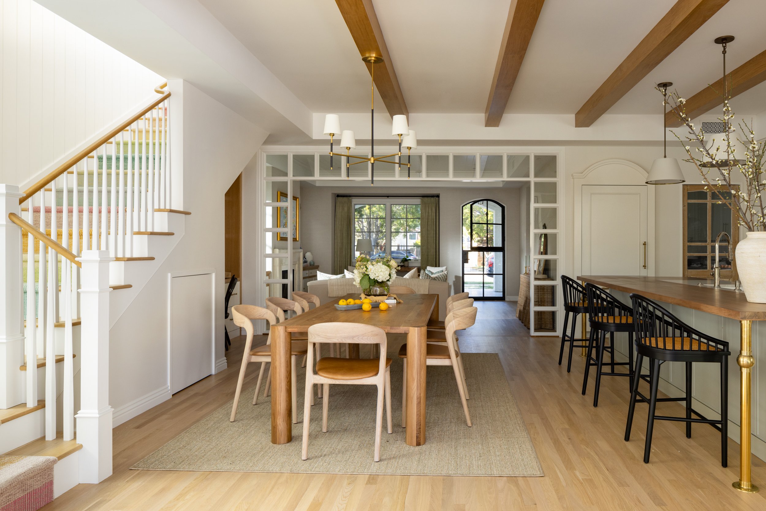 Elegant dining room featuring wooden ceiling beams and modern decor.