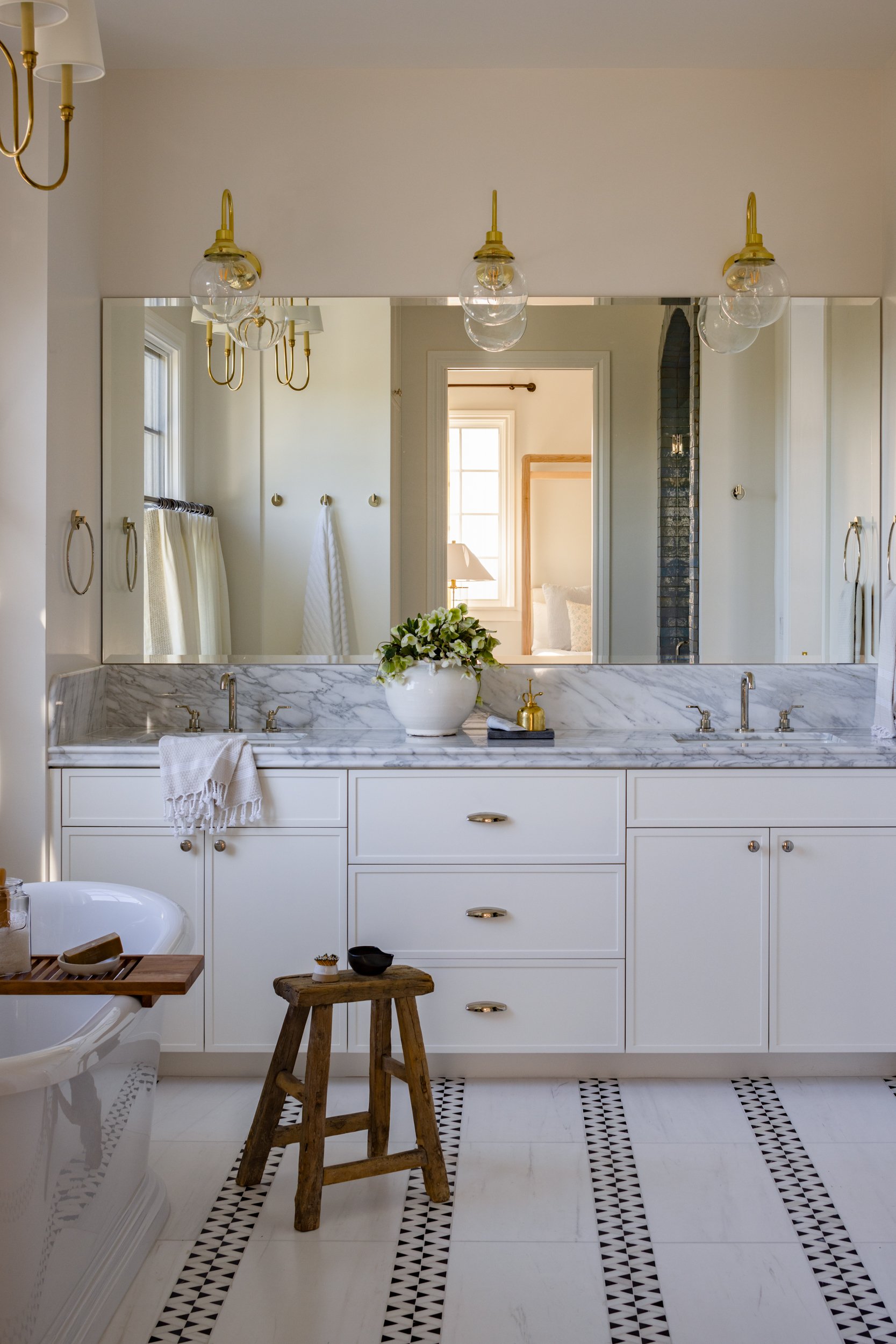 Bathroom mirror with lighting and marble countertop in Coronado G.