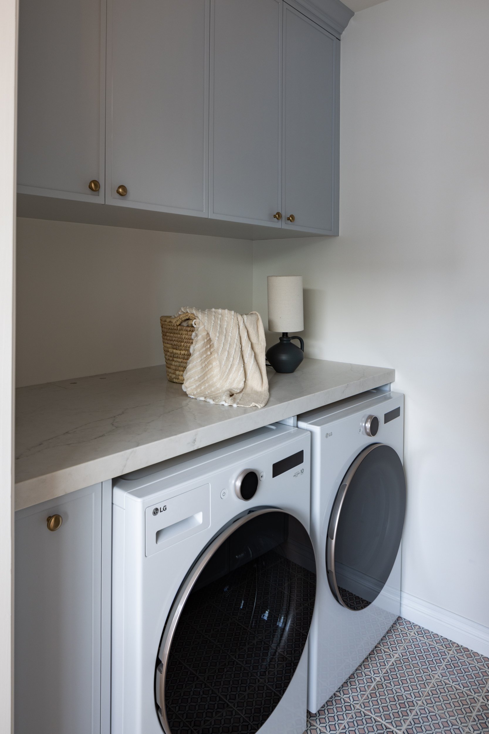 Laundry room with modern cabinetry and appliances.