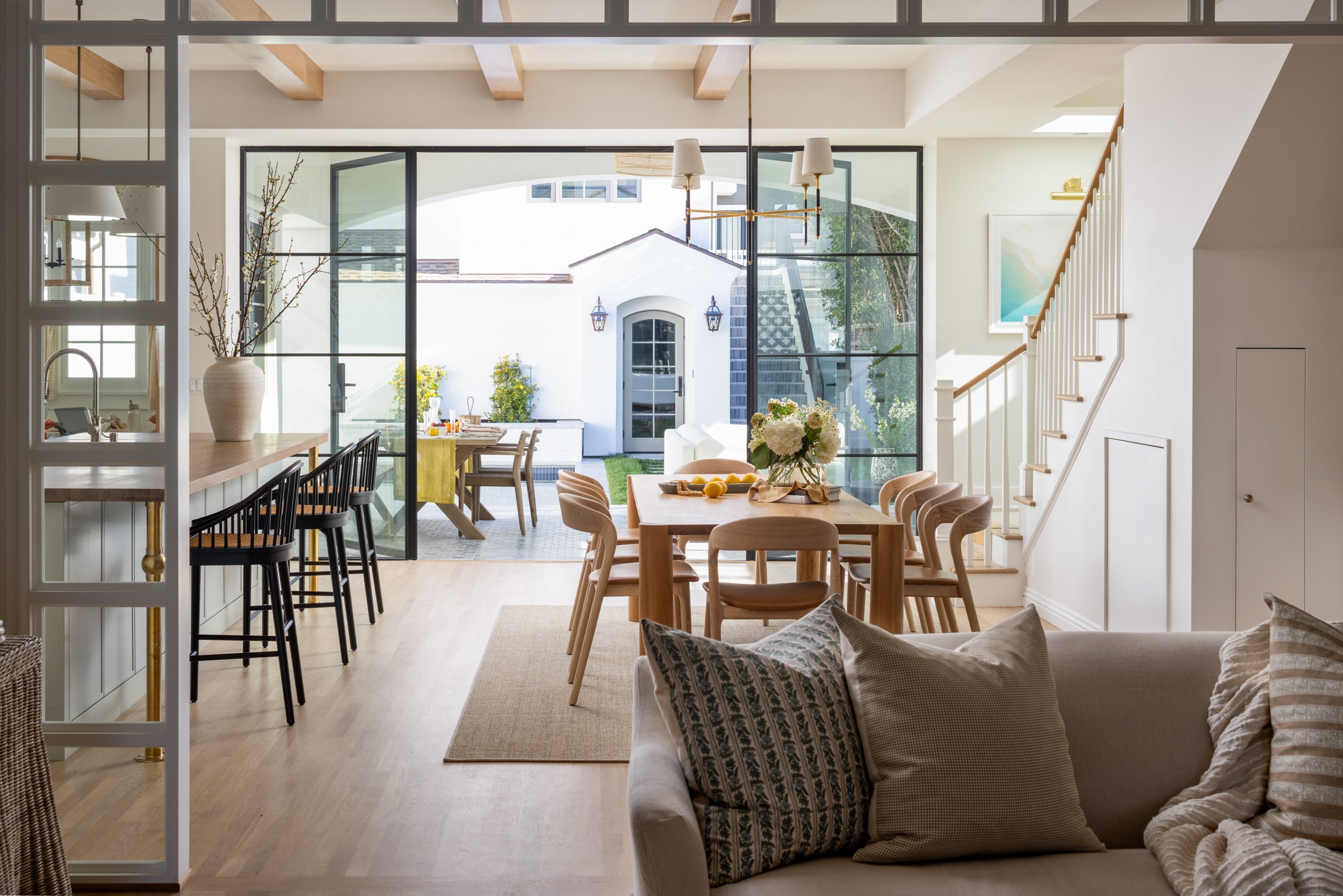 Elegant dining area with modern decor and large windows.