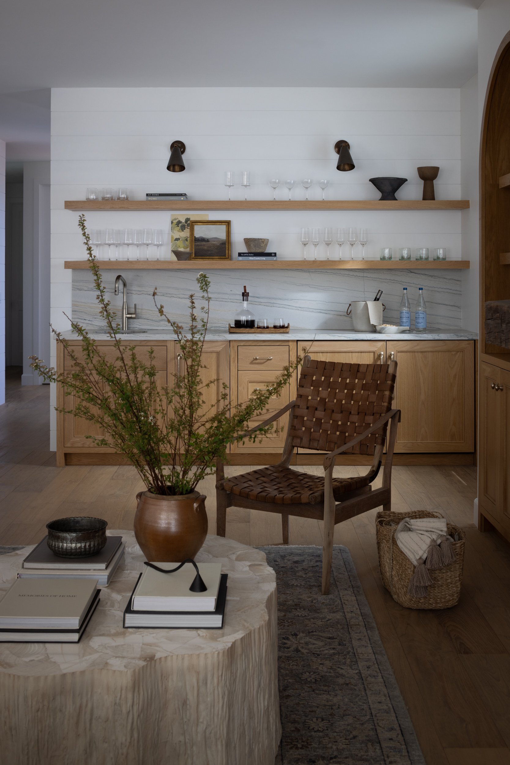Modern interior with wooden shelves and furniture, featuring a cozy seating area and decorative acce.