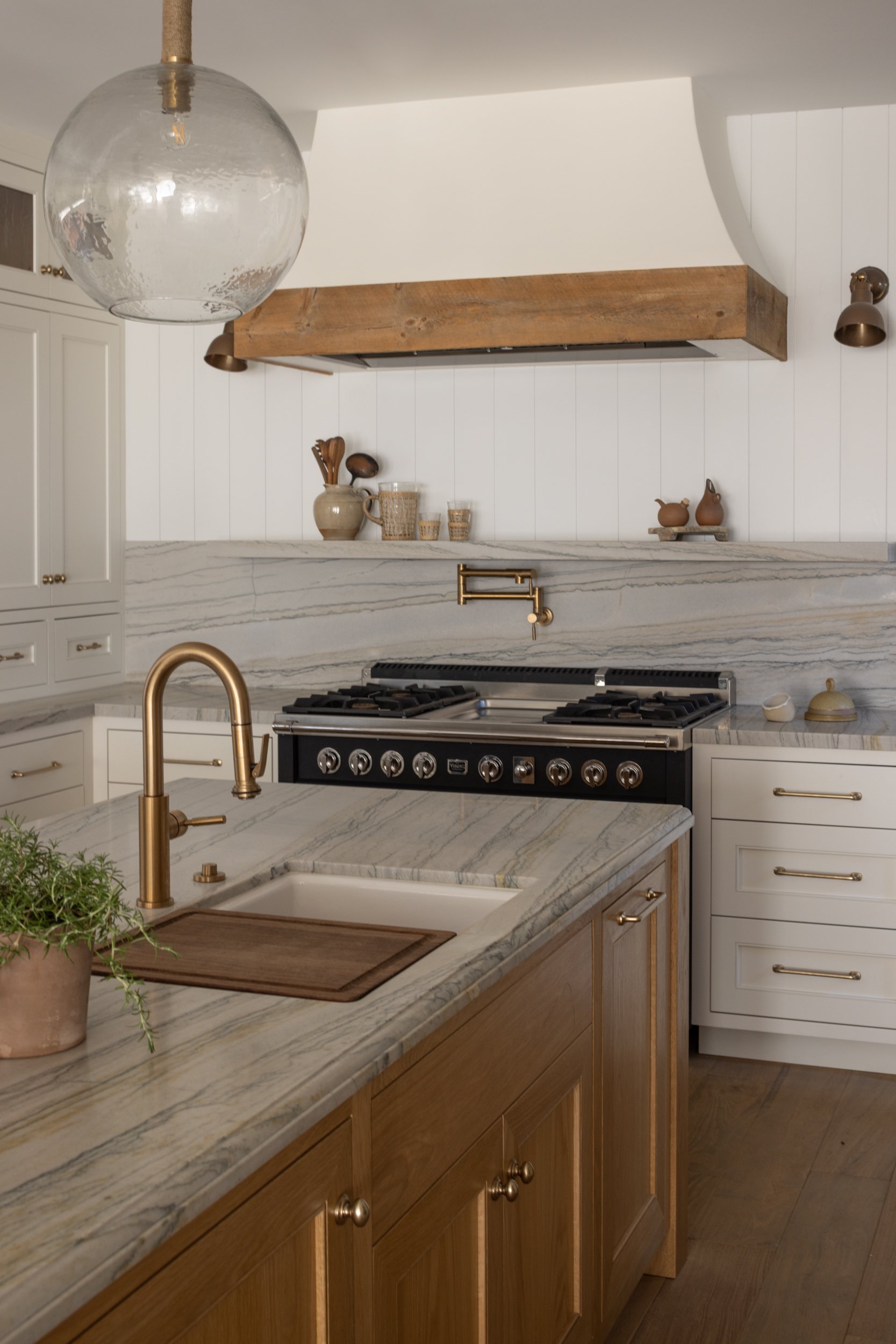 Modern Neptune-themed kitchen with wooden accents and brass fixtures.
