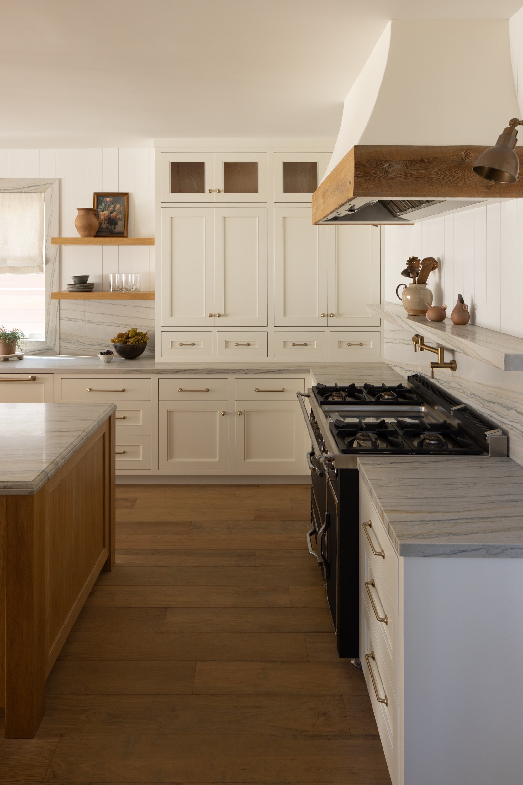 Bright coastal kitchen with white cabinetry and wooden accents, inspired by Neptune theme.