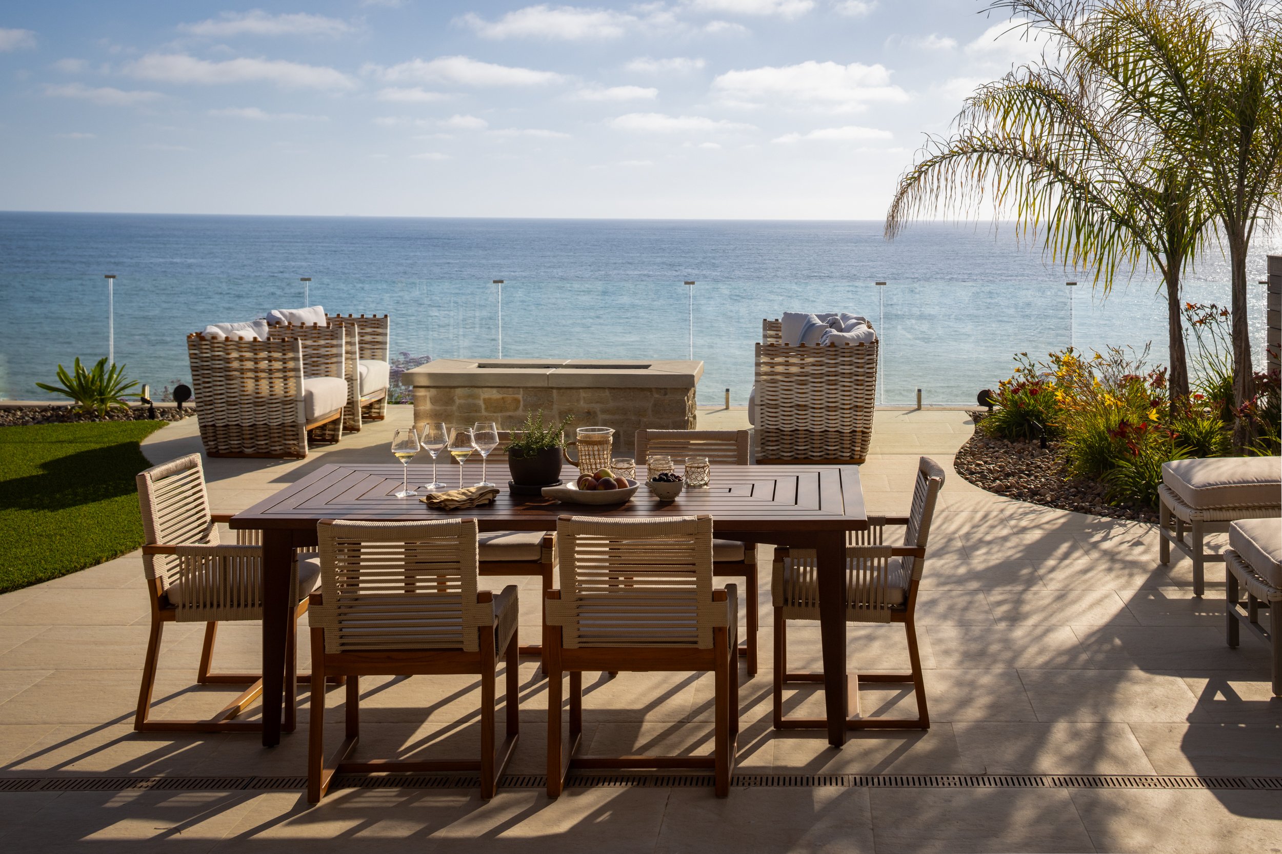 Outdoor dining setup with ocean view, perfect for relaxing seaside gatherings.