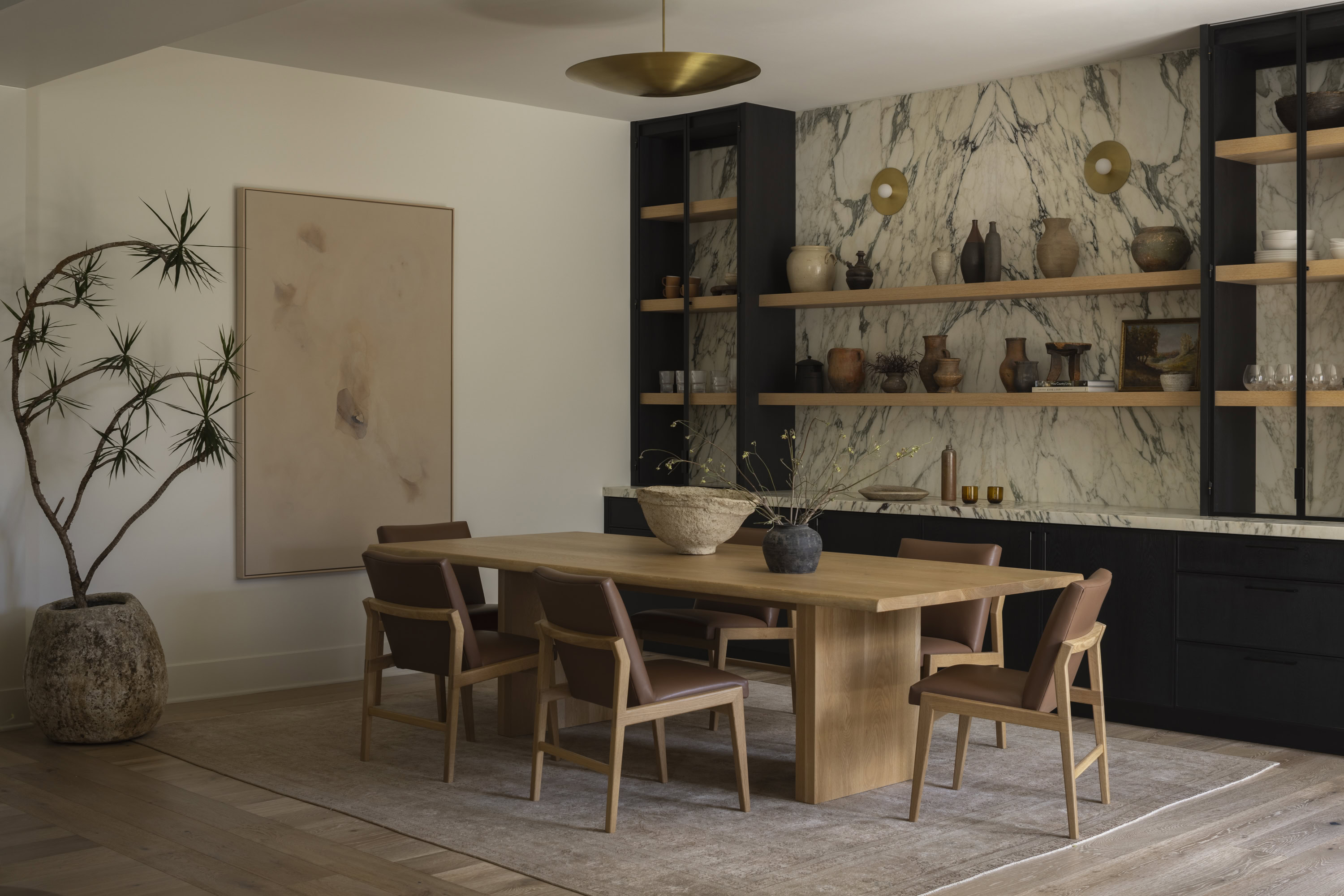 Stylish dining room featuring a wooden table and contemporary decor in a spacious setting.