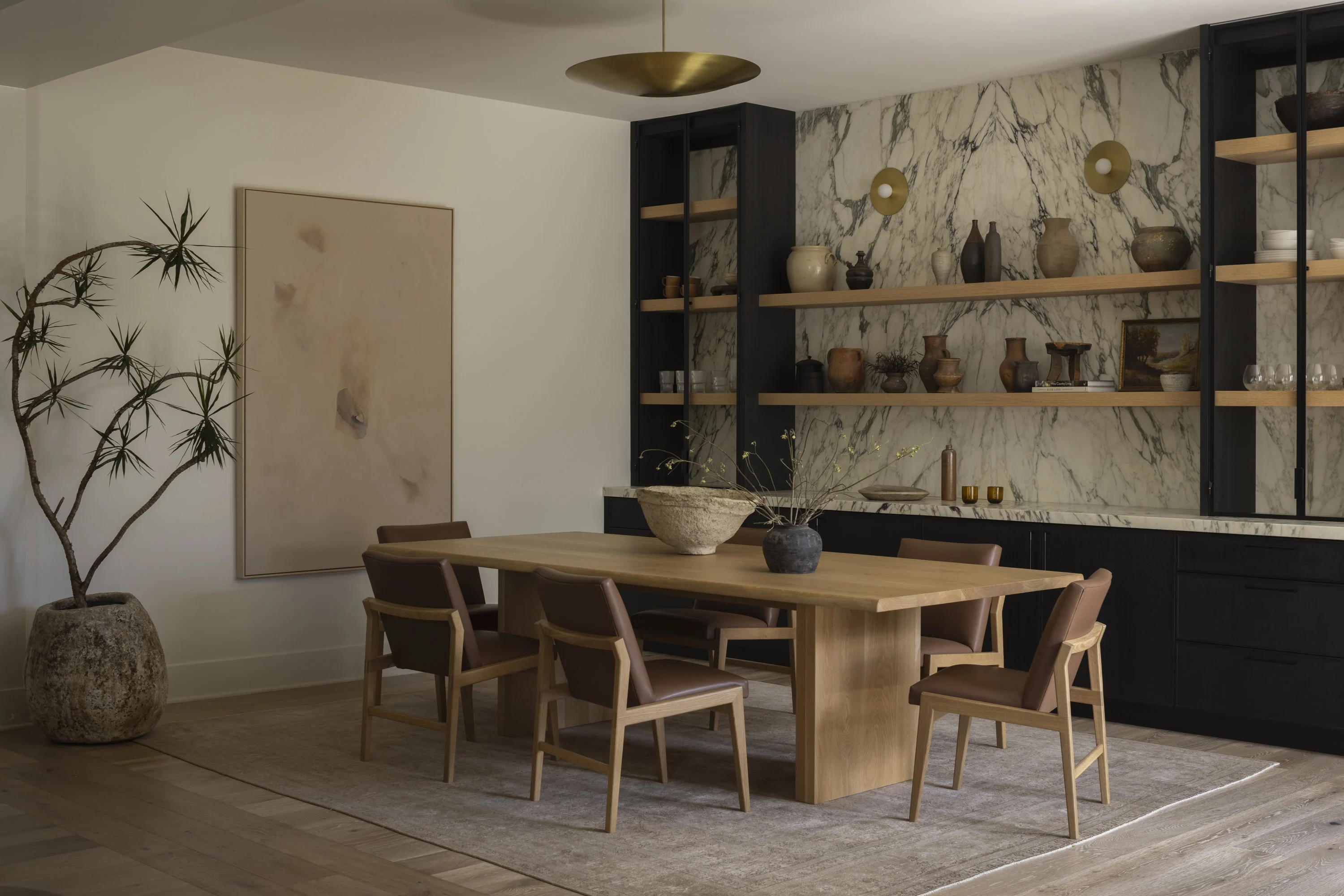 Stylish dining room featuring a wooden table and contemporary decor in a spacious setting.
