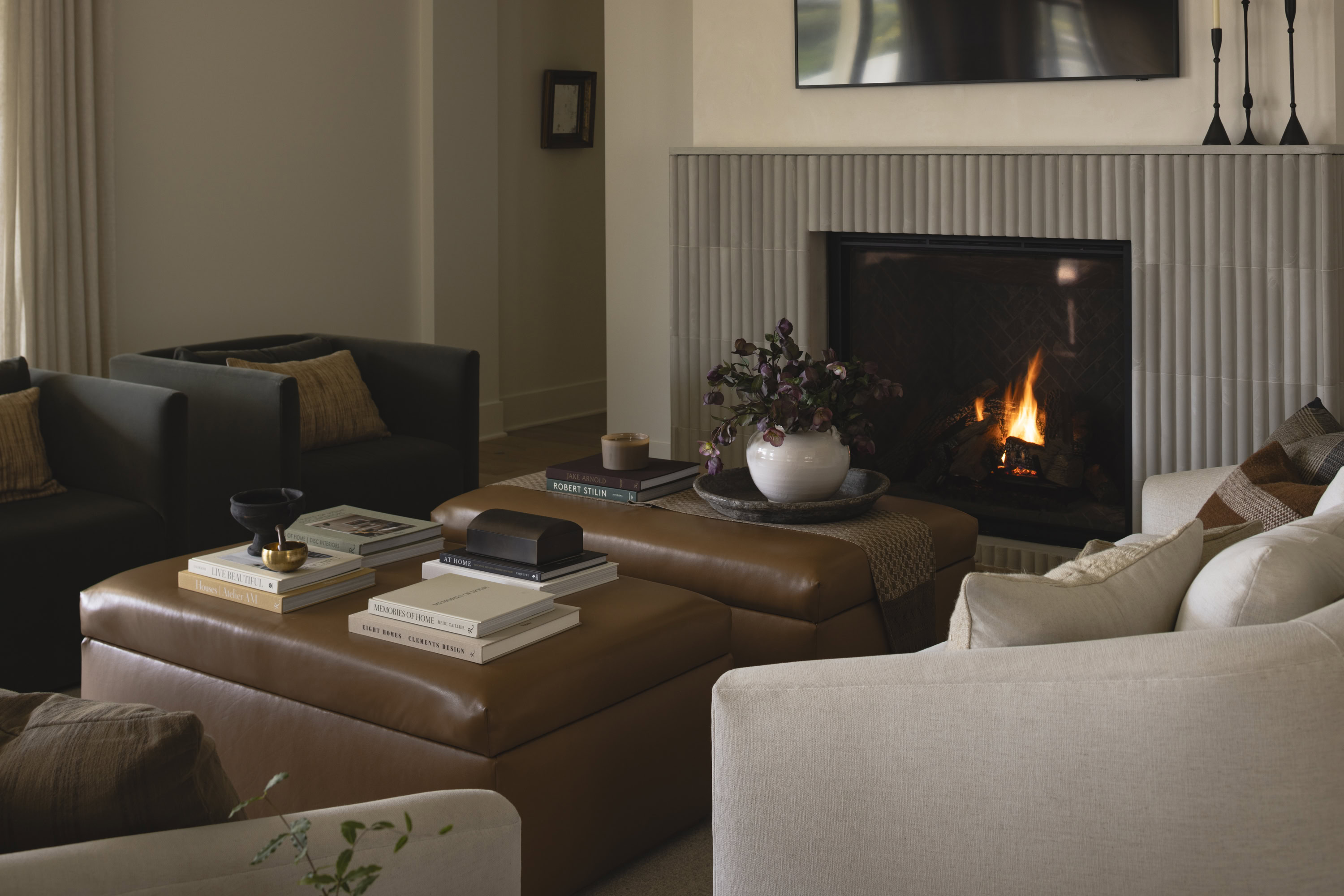 Cozy living room with modern furniture and a fireplace, showcasing stylish interior design in Rollin.