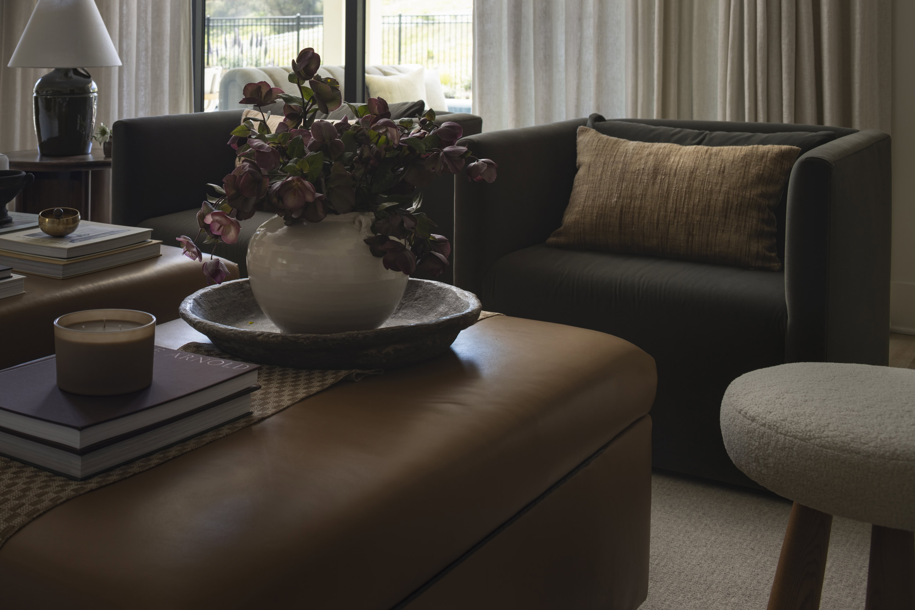 Modern living room with elegant furniture and floral decor.